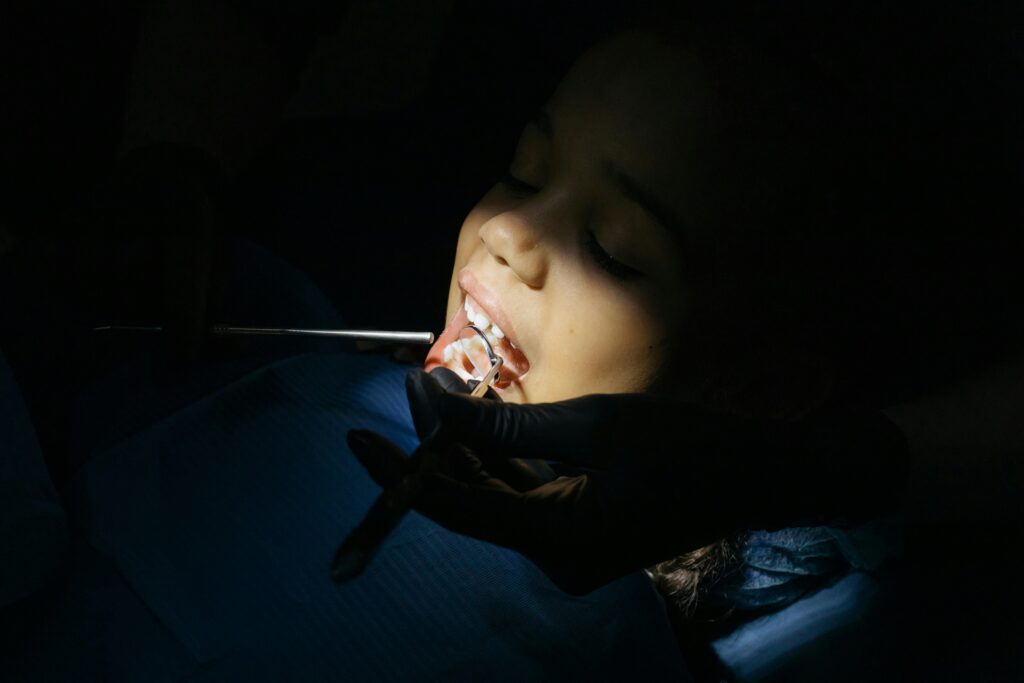 Close-up of a child undergoing a dental exam at a clinic, highlighting dental care procedures.